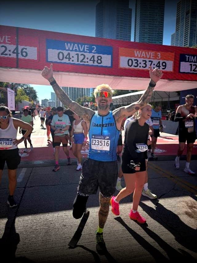 Arms up at the finish line of the 2025 Chicago Marathon