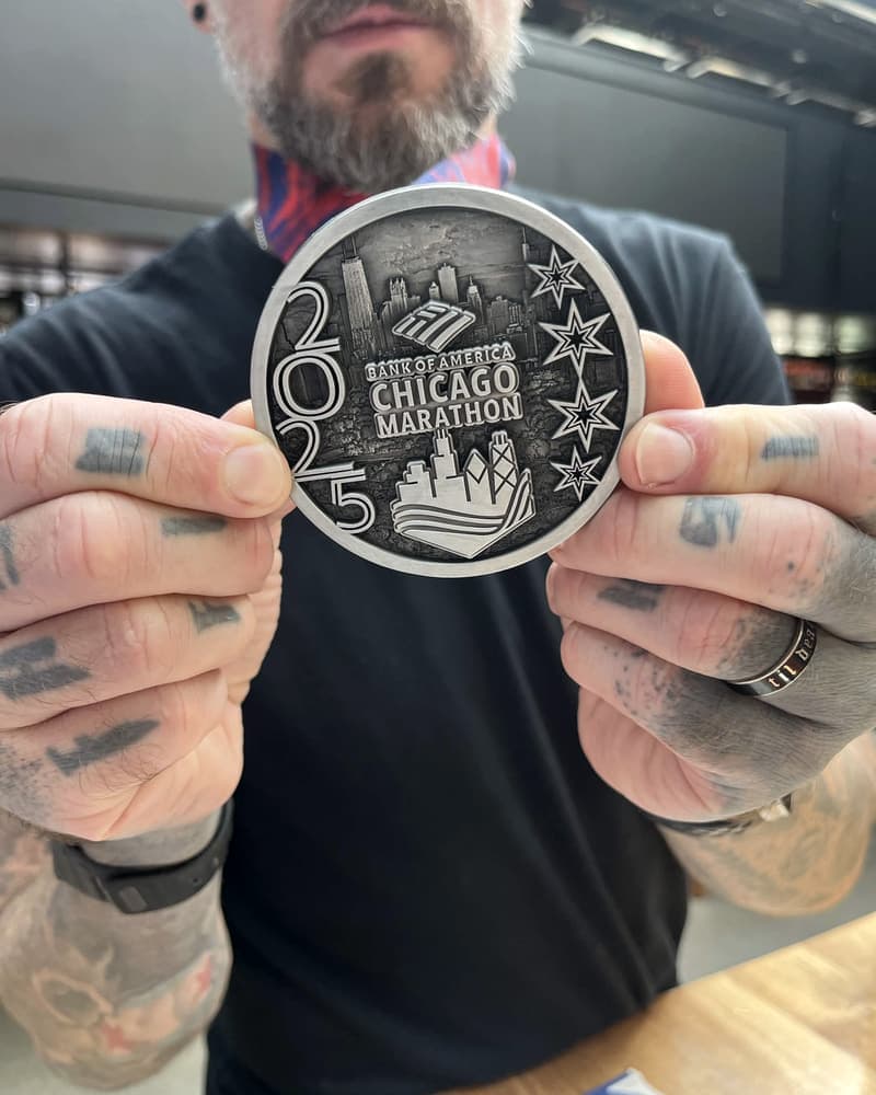 Holding up my 2025 Chicago Marathon medal