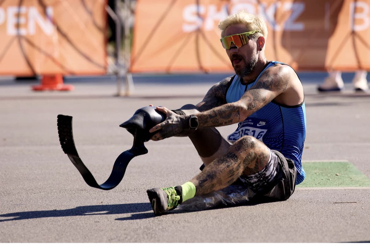 Sitting on the road mid-race in Chicago, fixing my prosthetic